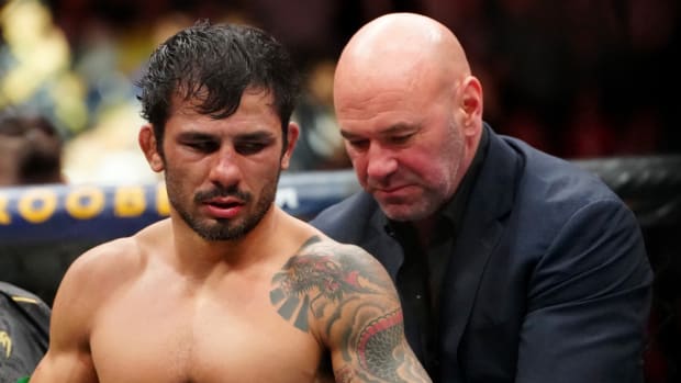 Dec 16, 2023; Las Vegas, Nevada, USA; Alexandre Pantoja (red gloves) is given the championship belt by UFC president Dana White after defeating Brandon Royval (not pictured) to win the UFC Flyweight title during UFC 296 at T-Mobile Arena. Mandatory Credit: Stephen R. Sylvanie-USA TODAY Sports